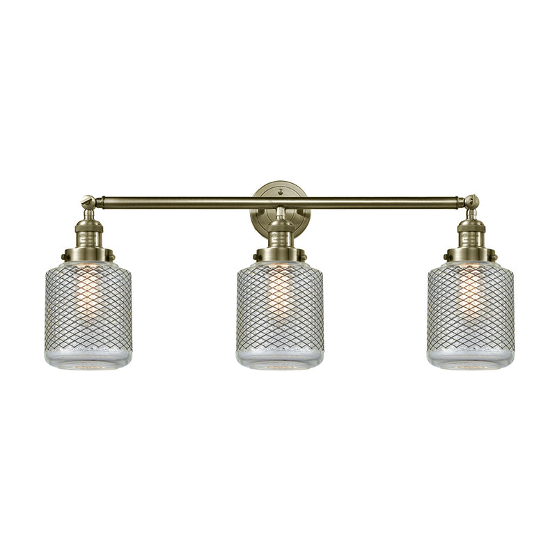 Stanton Bath Vanity Light shown in the Antique Brass finish with a Clear Wire Mesh shade
