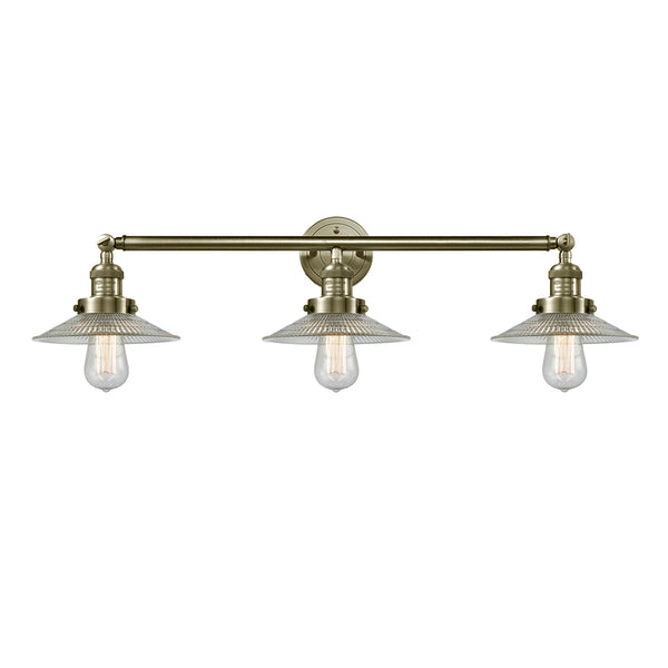 Halophane Bath Vanity Light shown in the Antique Brass finish with a Clear Halophane shade