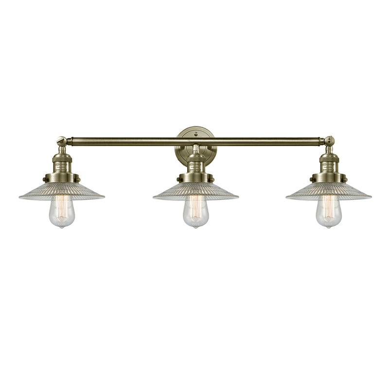 Halophane Bath Vanity Light shown in the Antique Brass finish with a Clear Halophane shade