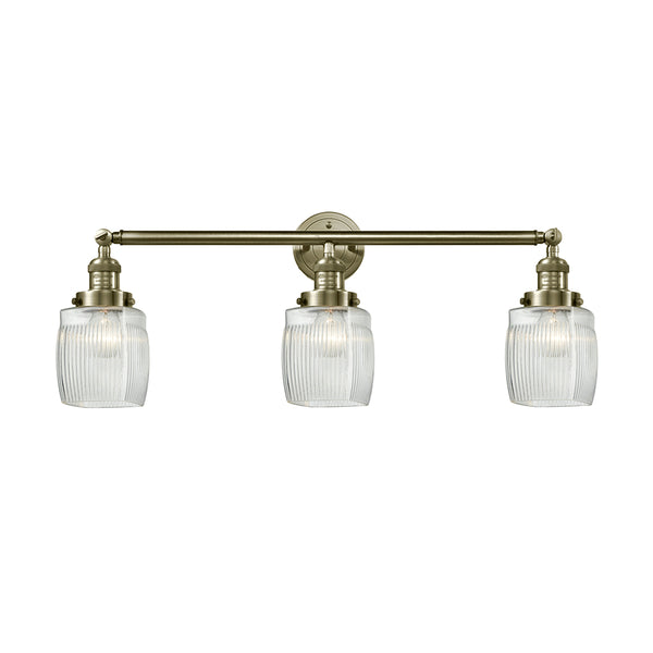 Colton Bath Vanity Light shown in the Antique Brass finish with a Clear Halophane shade