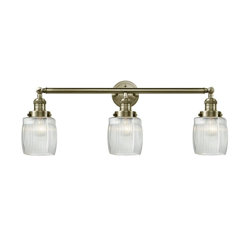 Colton Bath Vanity Light shown in the Antique Brass finish with a Clear Halophane shade