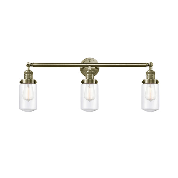 Dover Bath Vanity Light shown in the Antique Brass finish with a Clear shade