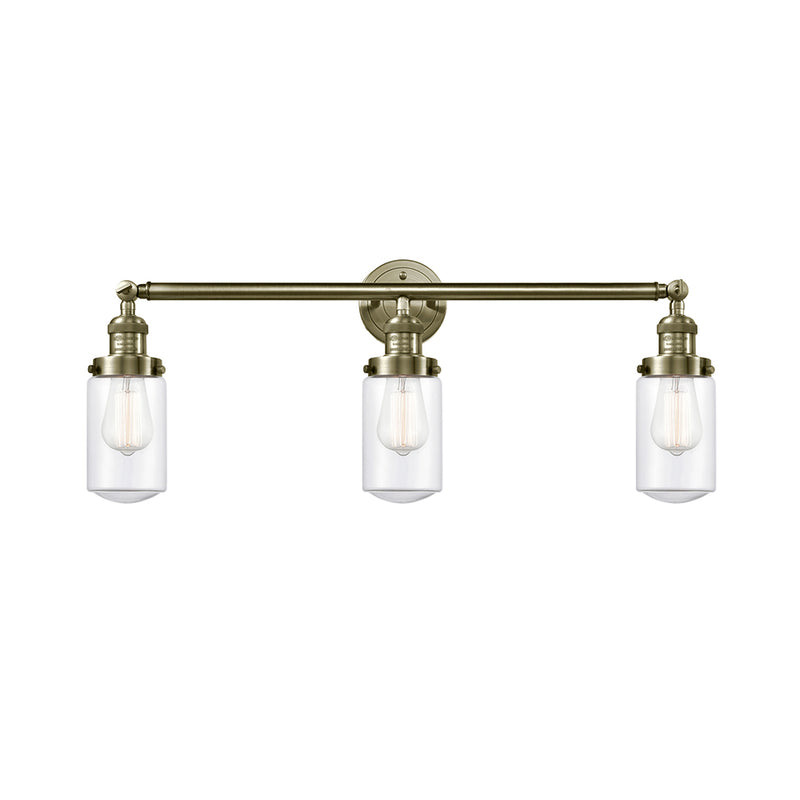 Dover Bath Vanity Light shown in the Antique Brass finish with a Clear shade
