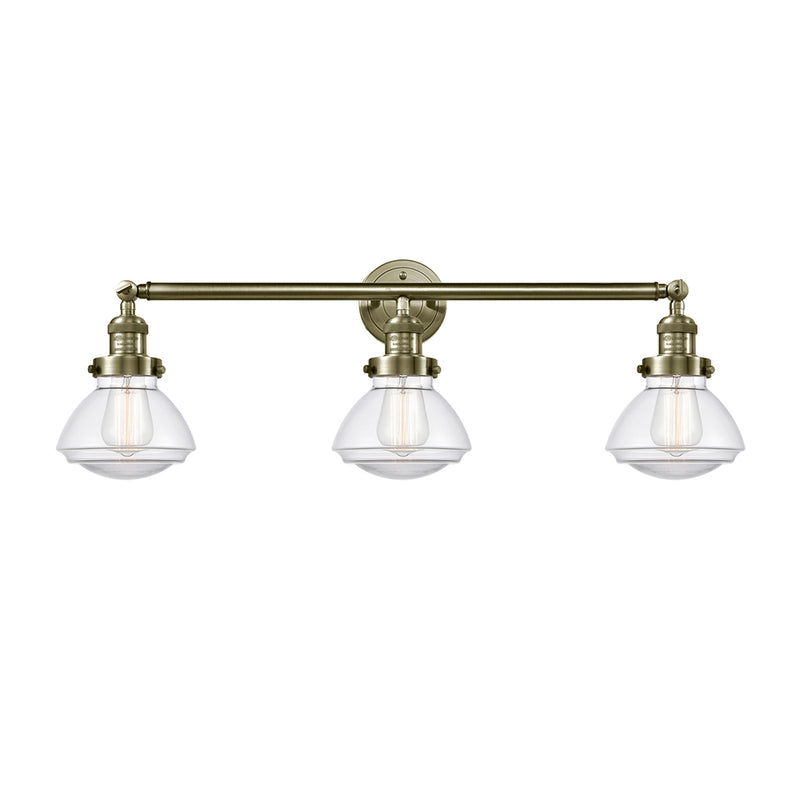 Olean Bath Vanity Light shown in the Antique Brass finish with a Clear shade