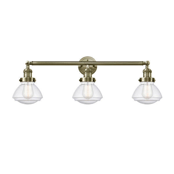 Olean Bath Vanity Light shown in the Antique Brass finish with a Seedy shade