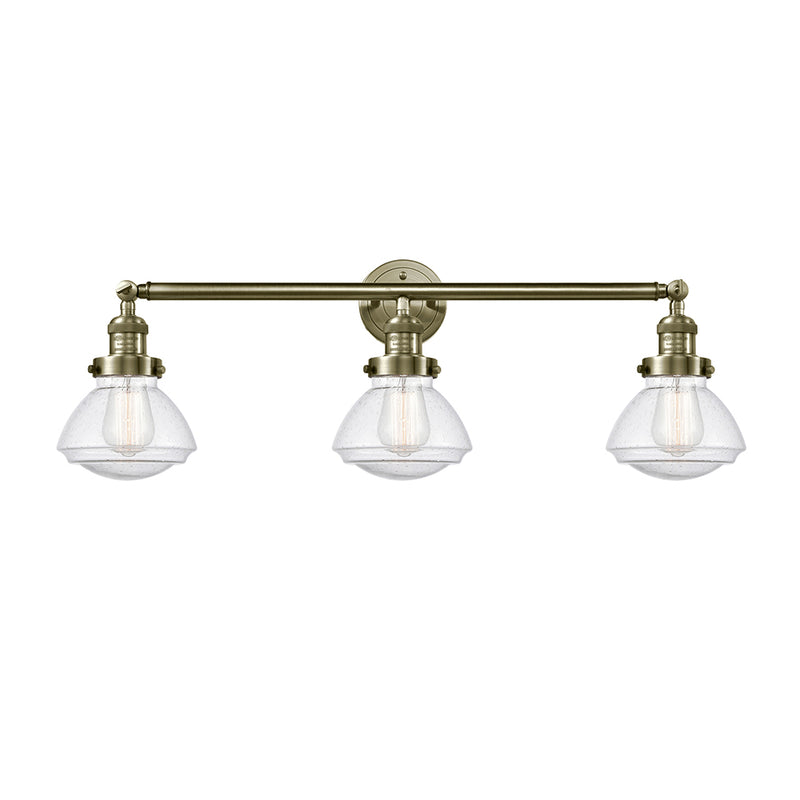 Olean Bath Vanity Light shown in the Antique Brass finish with a Seedy shade