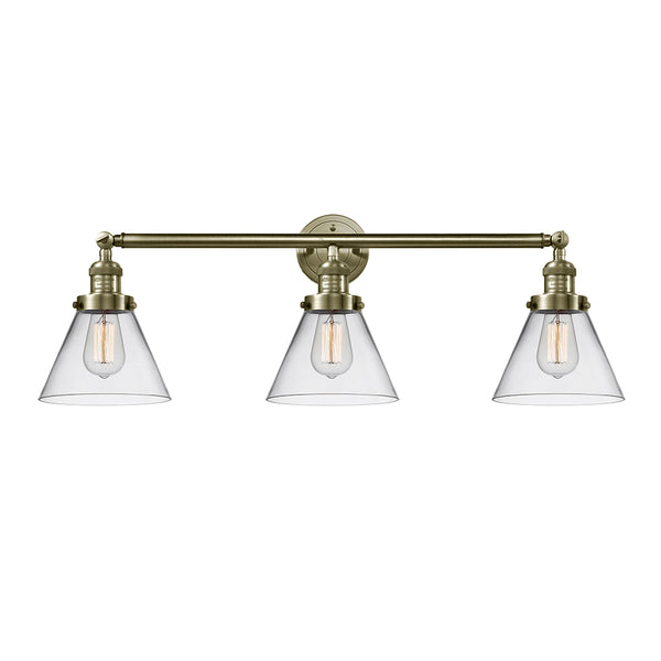 Cone Bath Vanity Light shown in the Antique Brass finish with a Clear shade