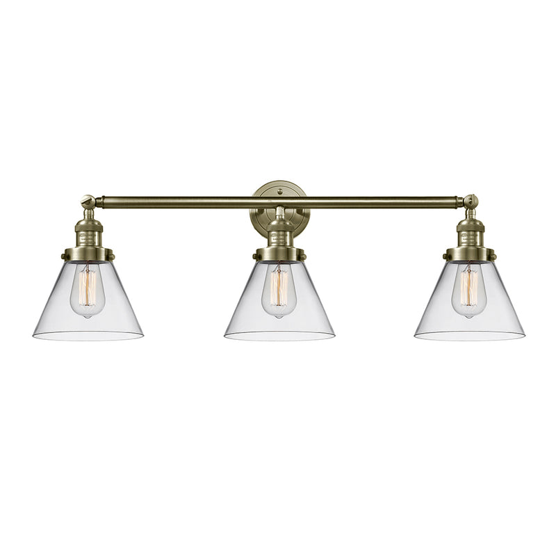 Cone Bath Vanity Light shown in the Antique Brass finish with a Clear shade