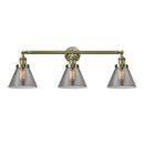Cone Bath Vanity Light shown in the Antique Brass finish with a Plated Smoke shade