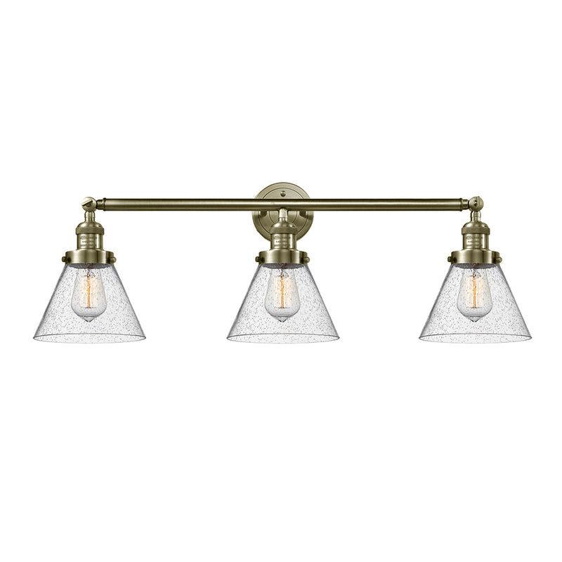 Cone Bath Vanity Light shown in the Antique Brass finish with a Seedy shade