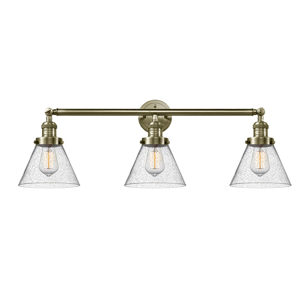 Cone Bath Vanity Light shown in the Antique Brass finish with a Seedy shade