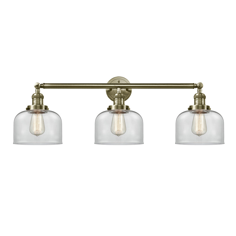 Bell Bath Vanity Light shown in the Antique Brass finish with a Clear shade