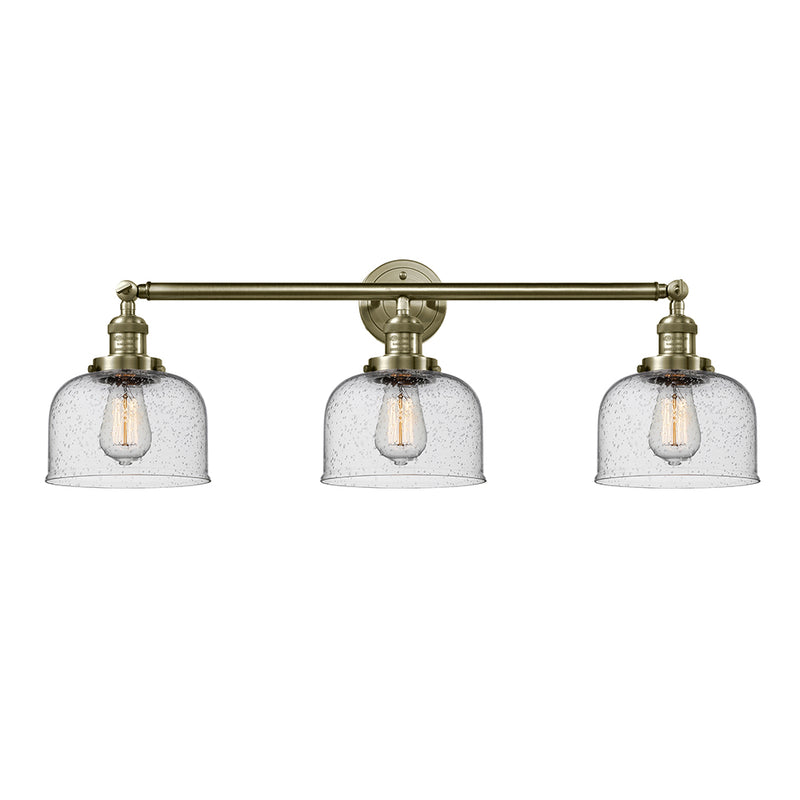Bell Bath Vanity Light shown in the Antique Brass finish with a Seedy shade