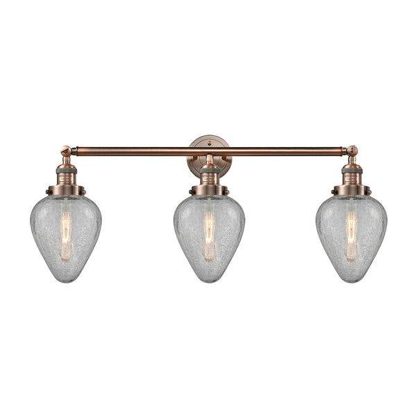 Geneseo Bath Vanity Light shown in the Antique Copper finish with a Clear Crackled shade