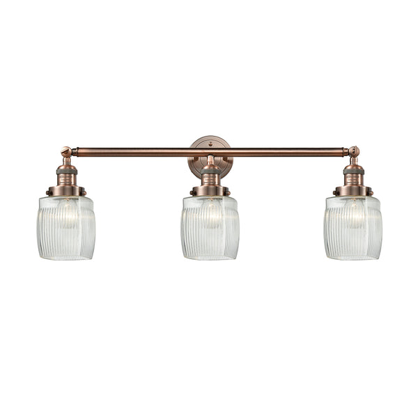 Colton Bath Vanity Light shown in the Antique Copper finish with a Clear Halophane shade