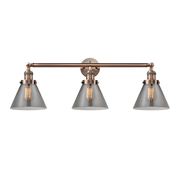 Cone Bath Vanity Light shown in the Antique Copper finish with a Plated Smoke shade