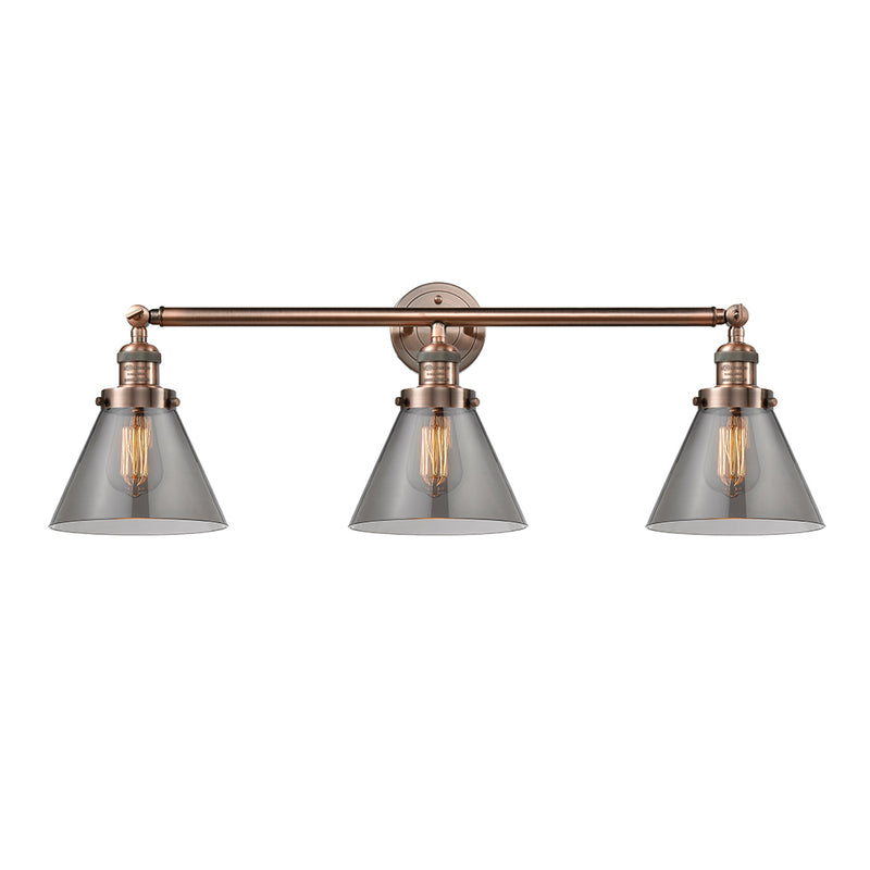 Cone Bath Vanity Light shown in the Antique Copper finish with a Plated Smoke shade