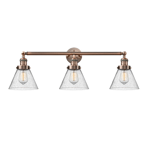 Cone Bath Vanity Light shown in the Antique Copper finish with a Seedy shade