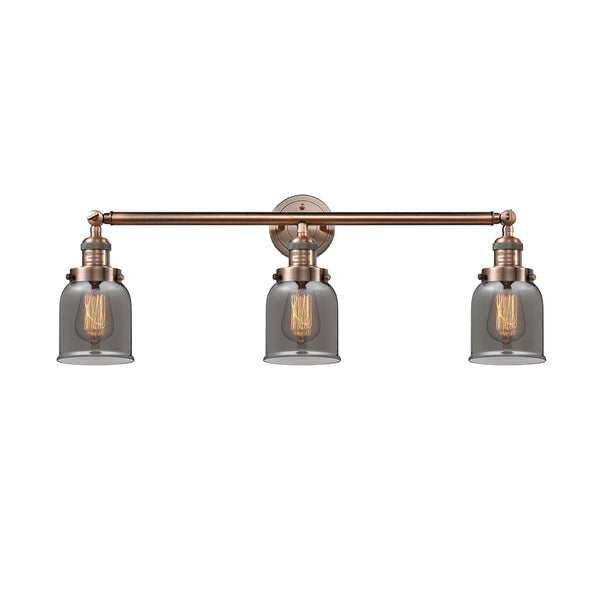 Bell Bath Vanity Light shown in the Antique Copper finish with a Plated Smoke shade