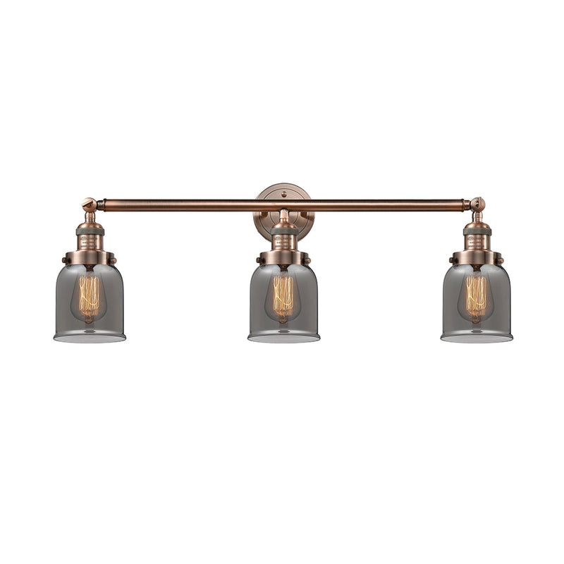 Bell Bath Vanity Light shown in the Antique Copper finish with a Plated Smoke shade