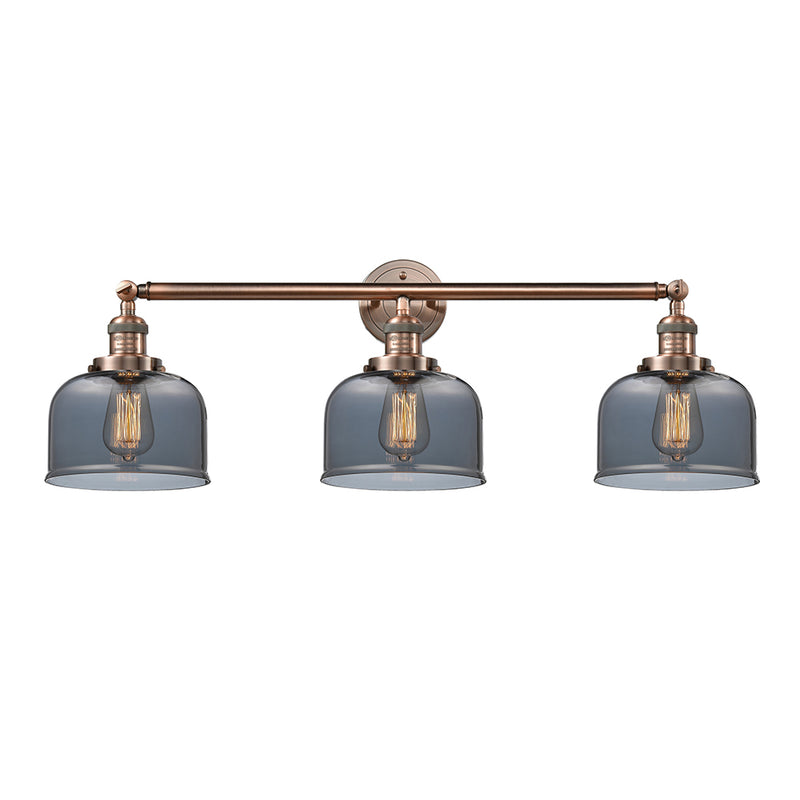 Bell Bath Vanity Light shown in the Antique Copper finish with a Plated Smoke shade