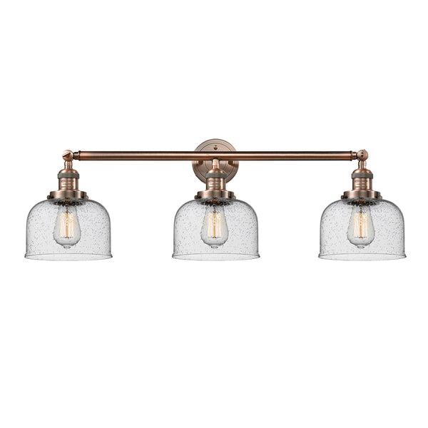 Bell Bath Vanity Light shown in the Antique Copper finish with a Seedy shade