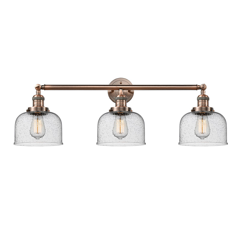 Bell Bath Vanity Light shown in the Antique Copper finish with a Seedy shade