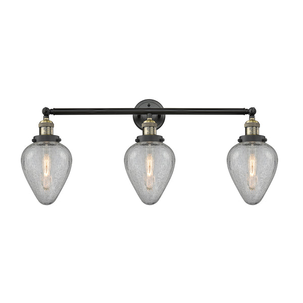 Geneseo Bath Vanity Light shown in the Black Antique Brass finish with a Clear Crackled shade