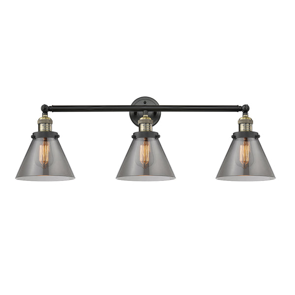 Cone Bath Vanity Light shown in the Black Antique Brass finish with a Plated Smoke shade