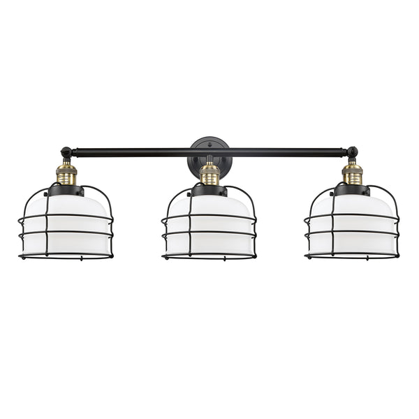 Bell Cage Bath Vanity Light shown in the Black Antique Brass finish with a Matte White shade