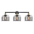 Bell Cage Bath Vanity Light shown in the Black Antique Brass finish with a Plated Smoke shade