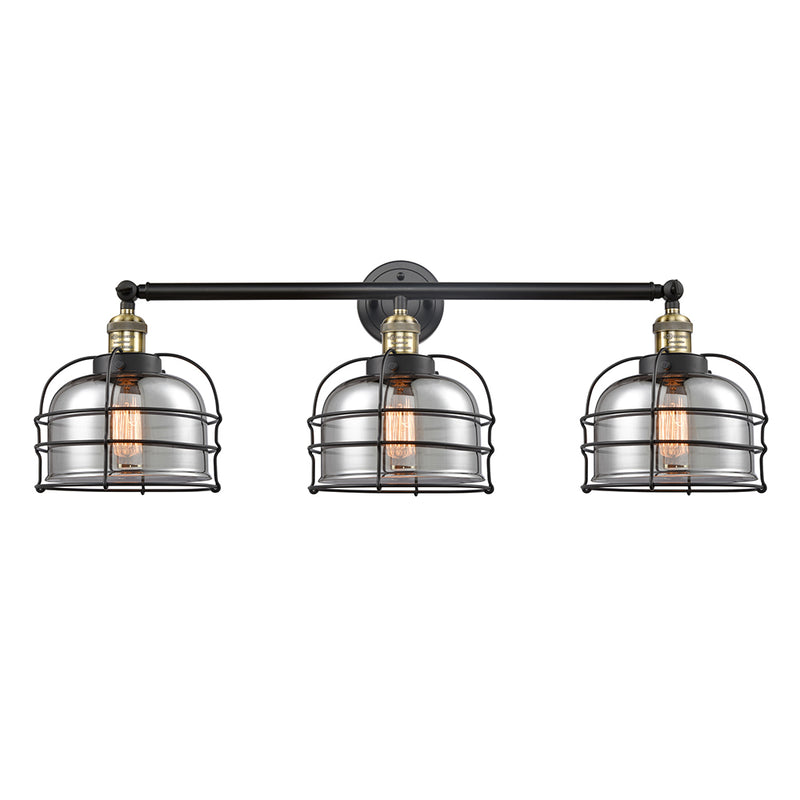 Bell Cage Bath Vanity Light shown in the Black Antique Brass finish with a Plated Smoke shade
