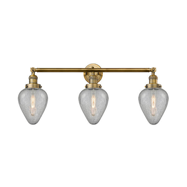 Geneseo Bath Vanity Light shown in the Brushed Brass finish with a Clear Crackled shade