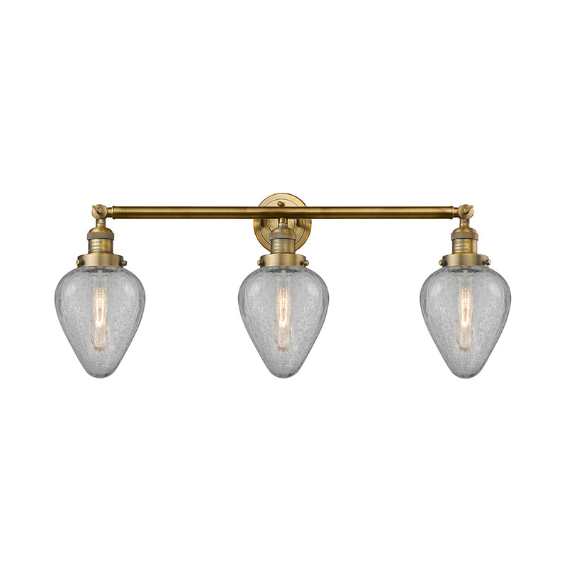 Geneseo Bath Vanity Light shown in the Brushed Brass finish with a Clear Crackled shade