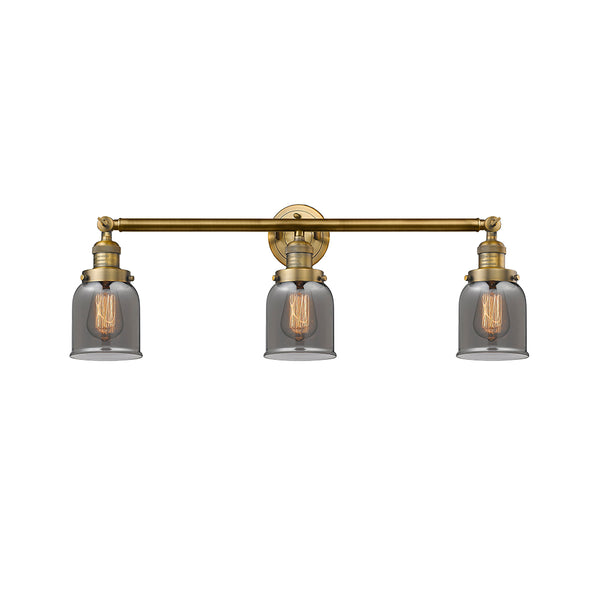 Bell Bath Vanity Light shown in the Brushed Brass finish with a Plated Smoke shade