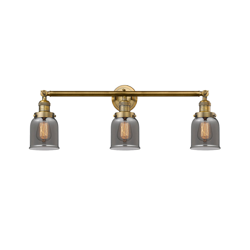 Bell Bath Vanity Light shown in the Brushed Brass finish with a Plated Smoke shade
