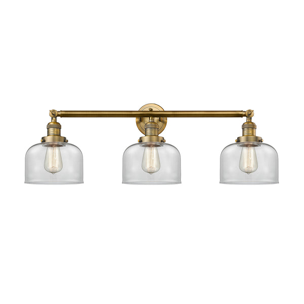 Bell Bath Vanity Light shown in the Brushed Brass finish with a Clear shade