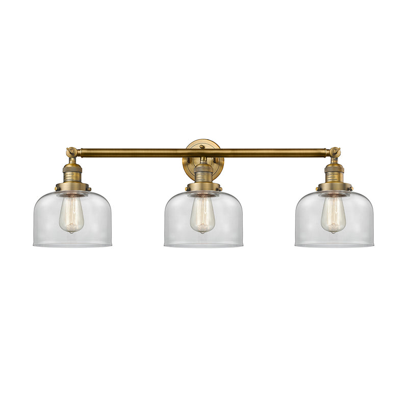 Bell Bath Vanity Light shown in the Brushed Brass finish with a Clear shade