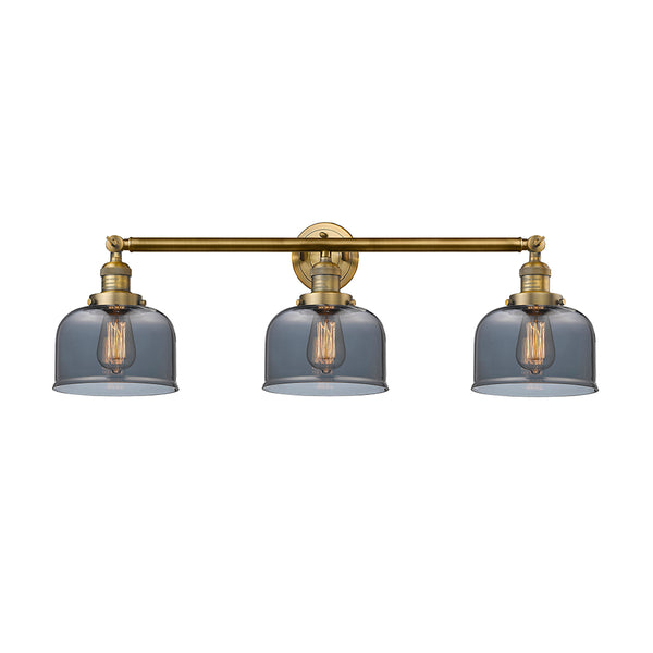 Bell Bath Vanity Light shown in the Brushed Brass finish with a Plated Smoke shade
