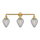 Geneseo Bath Vanity Light shown in the Satin Gold finish with a Clear Crackled shade