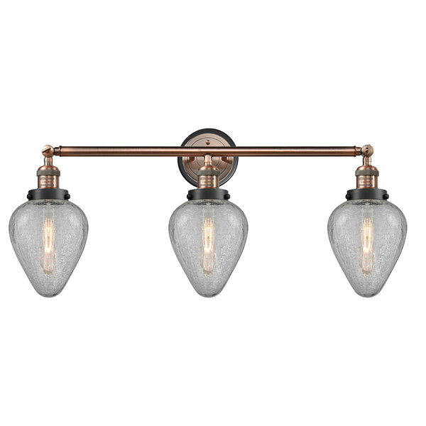 Geneseo Bath Vanity Light shown in the Antique Copper finish with a Clear Crackled shade