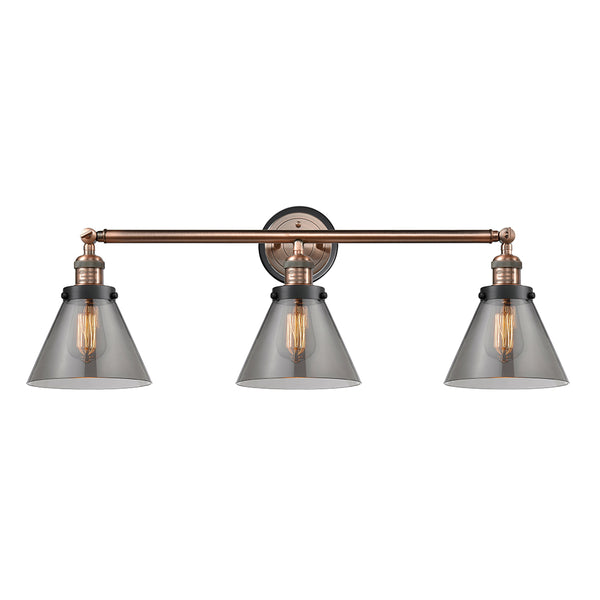 Cone Bath Vanity Light shown in the Antique Copper finish with a Plated Smoke shade