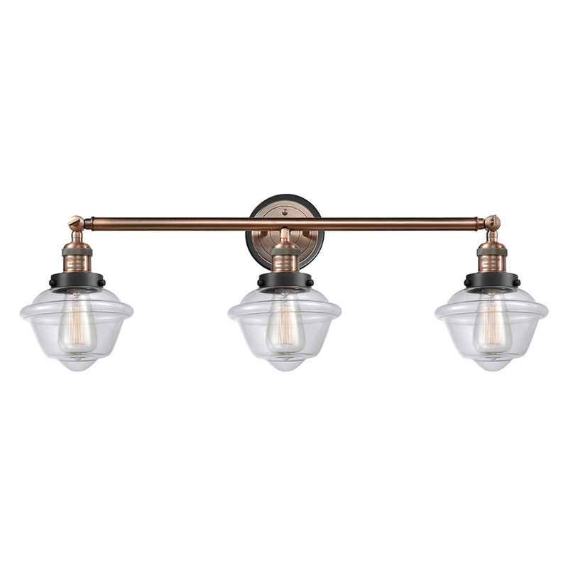 Oxford Bath Vanity Light shown in the Antique Copper finish with a Clear shade