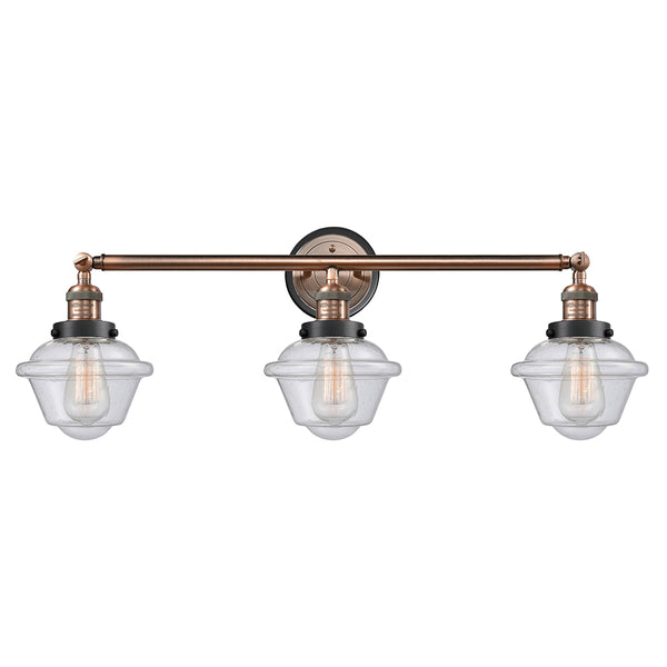 Oxford Bath Vanity Light shown in the Antique Copper finish with a Seedy shade