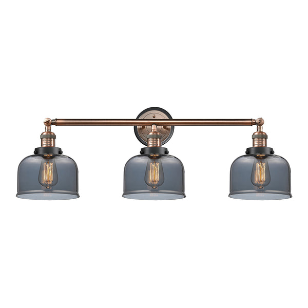 Bell Bath Vanity Light shown in the Antique Copper finish with a Plated Smoke shade