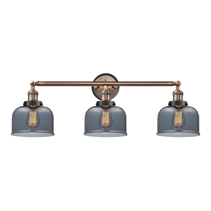 Bell Bath Vanity Light shown in the Antique Copper finish with a Plated Smoke shade