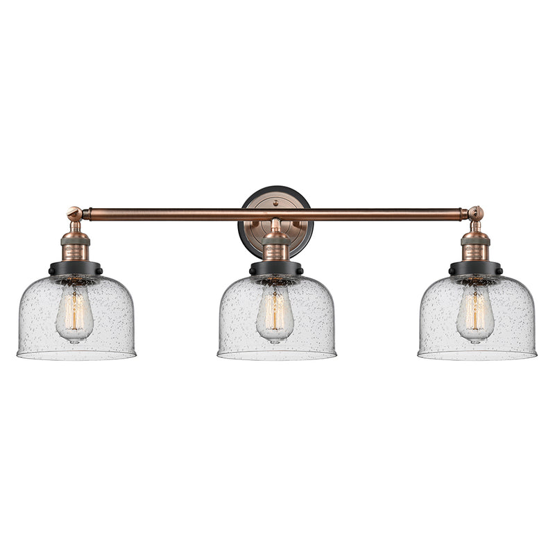 Bell Bath Vanity Light shown in the Antique Copper finish with a Seedy shade