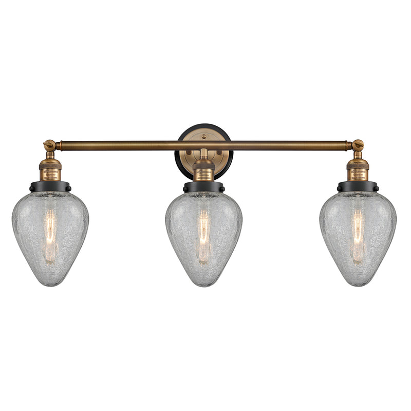 Geneseo Bath Vanity Light shown in the Brushed Brass finish with a Clear Crackled shade