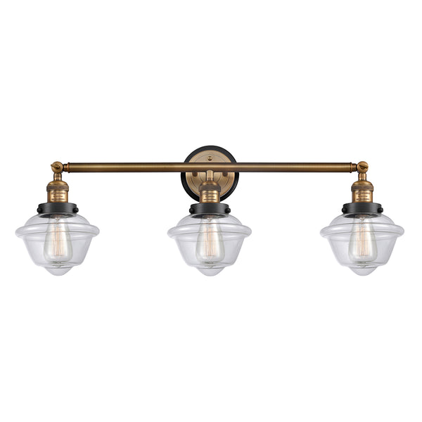 Oxford Bath Vanity Light shown in the Brushed Brass finish with a Clear shade