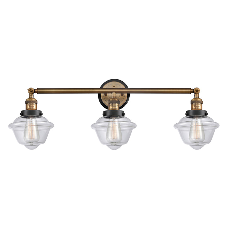 Oxford Bath Vanity Light shown in the Brushed Brass finish with a Clear shade